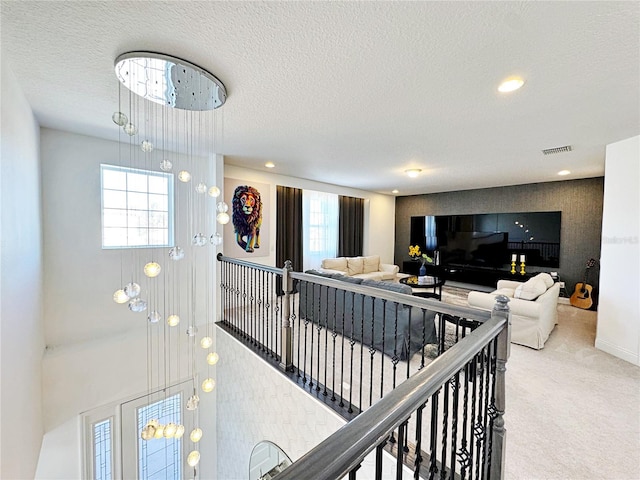 living room featuring a healthy amount of sunlight, carpet flooring, and a textured ceiling