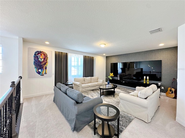 carpeted living room featuring a textured ceiling