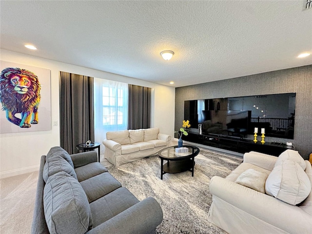 carpeted living room featuring a textured ceiling