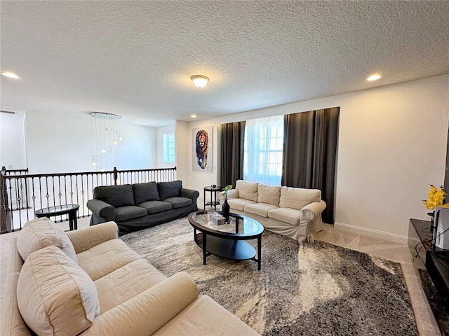 carpeted living room featuring a textured ceiling