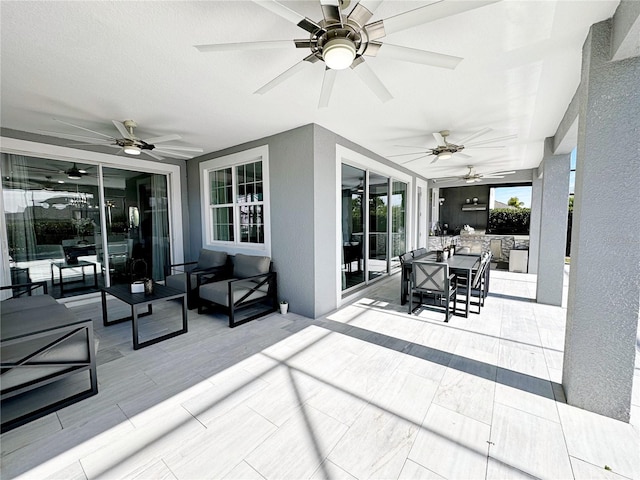 view of patio featuring an outdoor hangout area, ceiling fan, and an outdoor kitchen