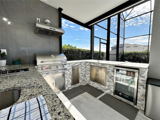 view of patio / terrace with an outdoor kitchen, area for grilling, sink, wine cooler, and glass enclosure