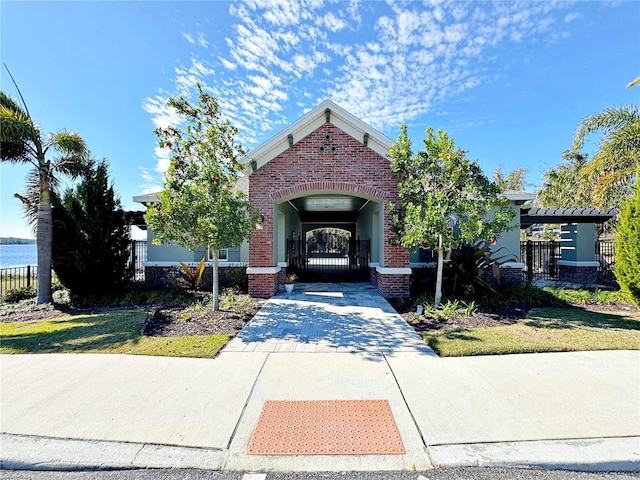 view of front of house featuring a water view and a front lawn