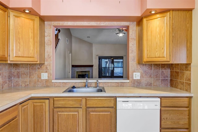 3002 Clubview Dr, Orlando, FL 32822 - kitchen with white dishwasher, a sink, light countertops, backsplash, and recessed lighting
