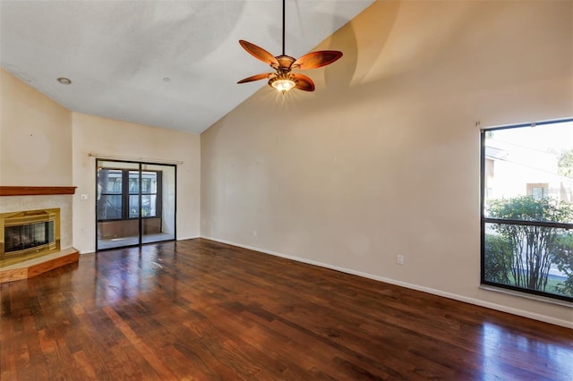 3002 Clubview Dr, Orlando, FL 32822 - unfurnished living room featuring wood finished floors, ceiling fan, high vaulted ceiling, a tiled fireplace, and baseboards