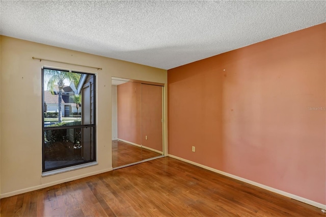 3002 Clubview Dr, Orlando, FL 32822 - spare room featuring wood finished floors, a textured ceiling, and baseboards