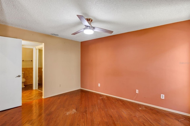 3002 Clubview Dr, Orlando, FL 32822 - spare room with a ceiling fan, a textured ceiling, wood finished floors, and baseboards