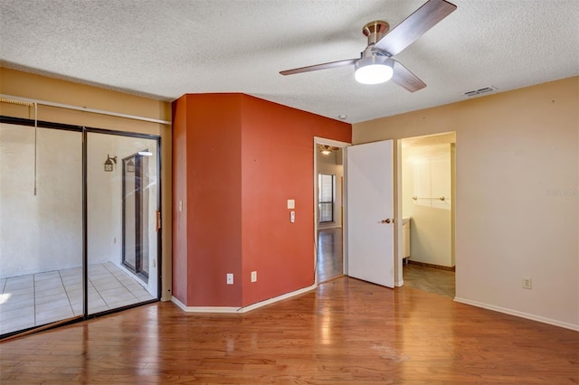 3002 Clubview Dr, Orlando, FL 32822 - unfurnished bedroom featuring wood finished floors, a textured ceiling, baseboards, and ceiling fan