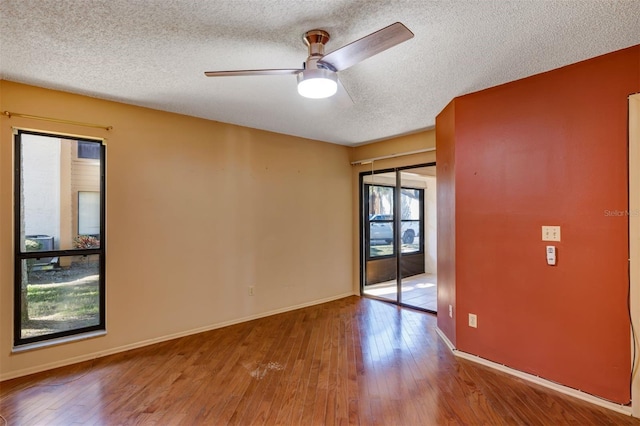 3002 Clubview Dr, Orlando, FL 32822 - unfurnished room with a textured ceiling, hardwood / wood-style floors, ceiling fan, and baseboards