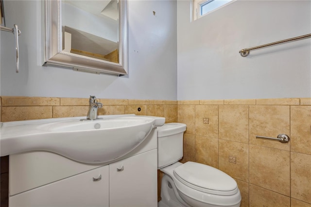 3002 Clubview Dr, Orlando, FL 32822 - half bathroom with tile walls, vanity, toilet, and a wainscoted wall