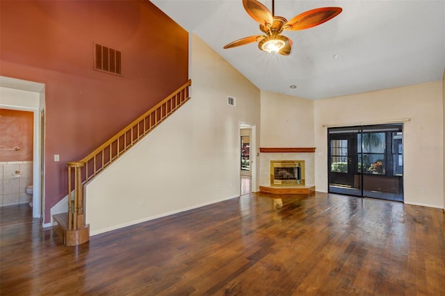 3002 Clubview Dr, Orlando, FL 32822 - unfurnished living room with high vaulted ceiling, a ceiling fan, wood finished floors, stairway, and a glass covered fireplace