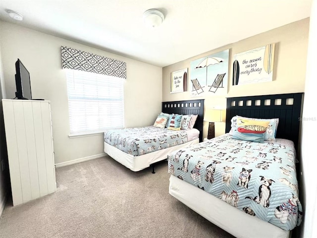 carpeted bedroom featuring baseboards