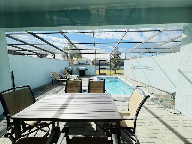 pool featuring outdoor dining area, a patio, and a lanai