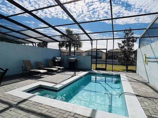 outdoor pool featuring a lanai, area for grilling, and a patio