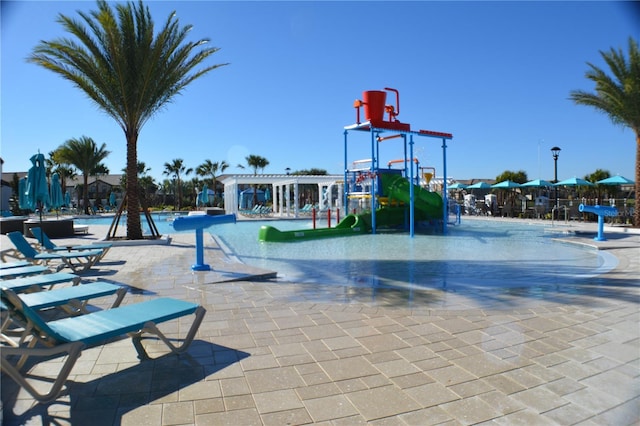 communal playground with a water play area and a community pool