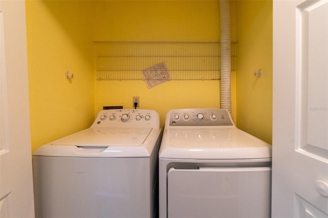 washroom featuring laundry area and washing machine and clothes dryer