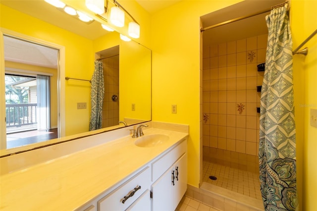 full bathroom featuring a stall shower, tile patterned flooring, and vanity