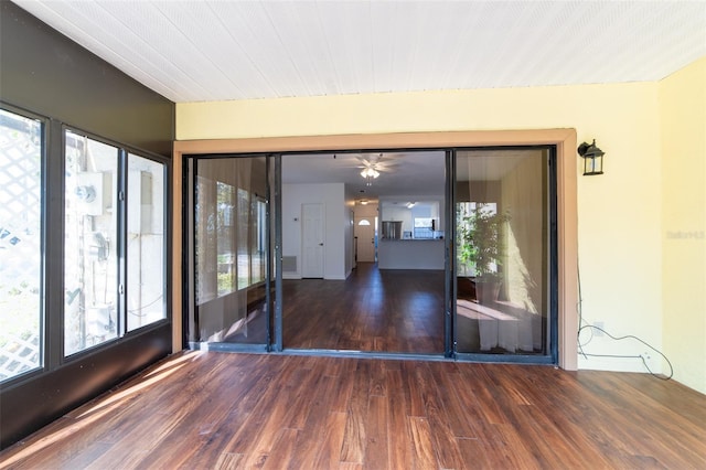 unfurnished room featuring plenty of natural light and dark wood finished floors