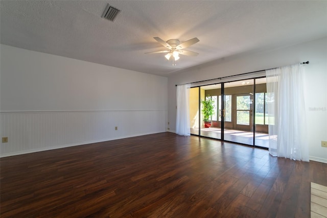 empty room with dark wood-style flooring, french doors, visible vents, ceiling fan, and a textured ceiling