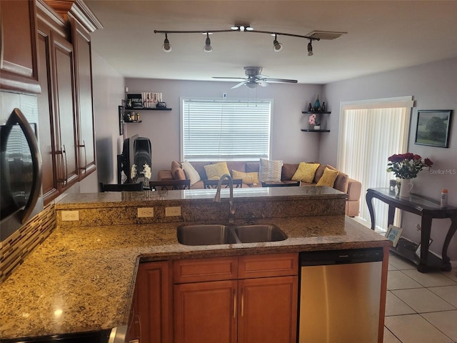 kitchen with sink, rail lighting, ceiling fan, light tile patterned flooring, and stainless steel dishwasher