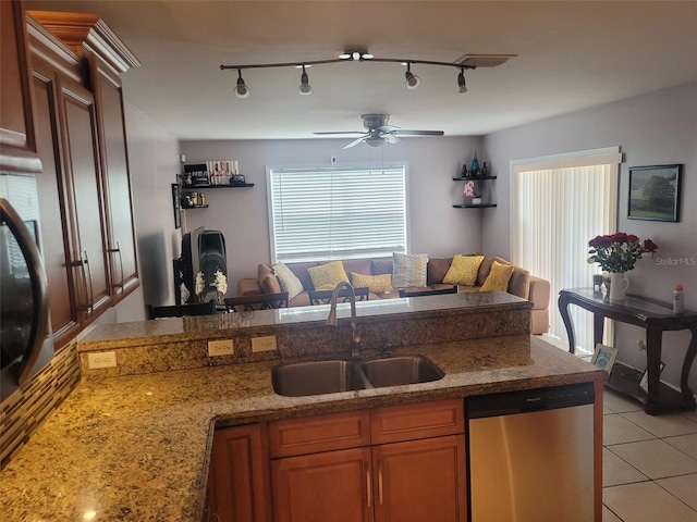 kitchen featuring sink, rail lighting, ceiling fan, light tile patterned flooring, and stainless steel dishwasher