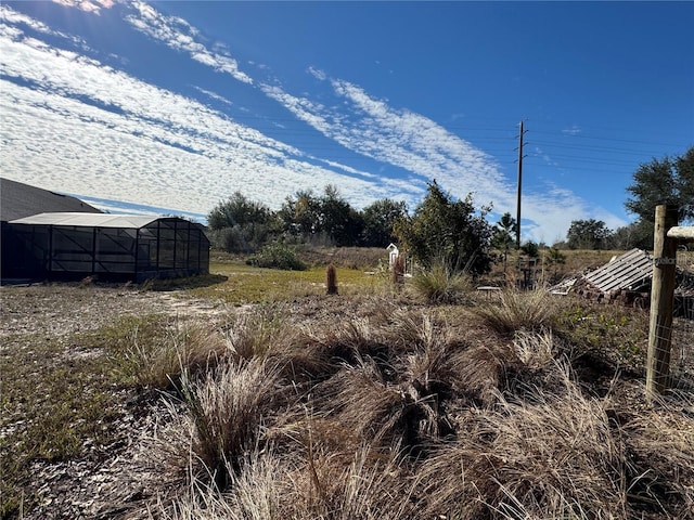 view of yard featuring a rural view and an outbuilding