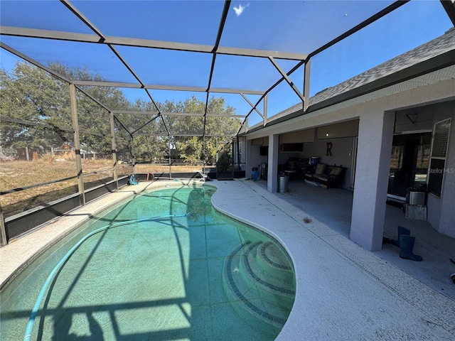 view of swimming pool with a patio and glass enclosure