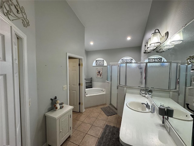 bathroom with tile patterned flooring, shower with separate bathtub, and vanity