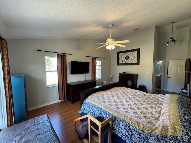 bedroom with hardwood / wood-style flooring, vaulted ceiling, ensuite bathroom, and ceiling fan