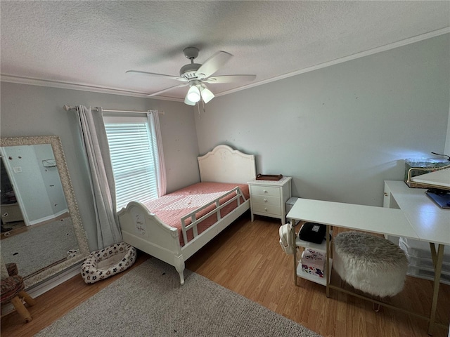 bedroom with crown molding, hardwood / wood-style flooring, and ceiling fan