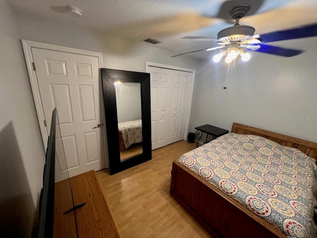 bedroom with ceiling fan, a textured ceiling, a closet, and light wood-type flooring