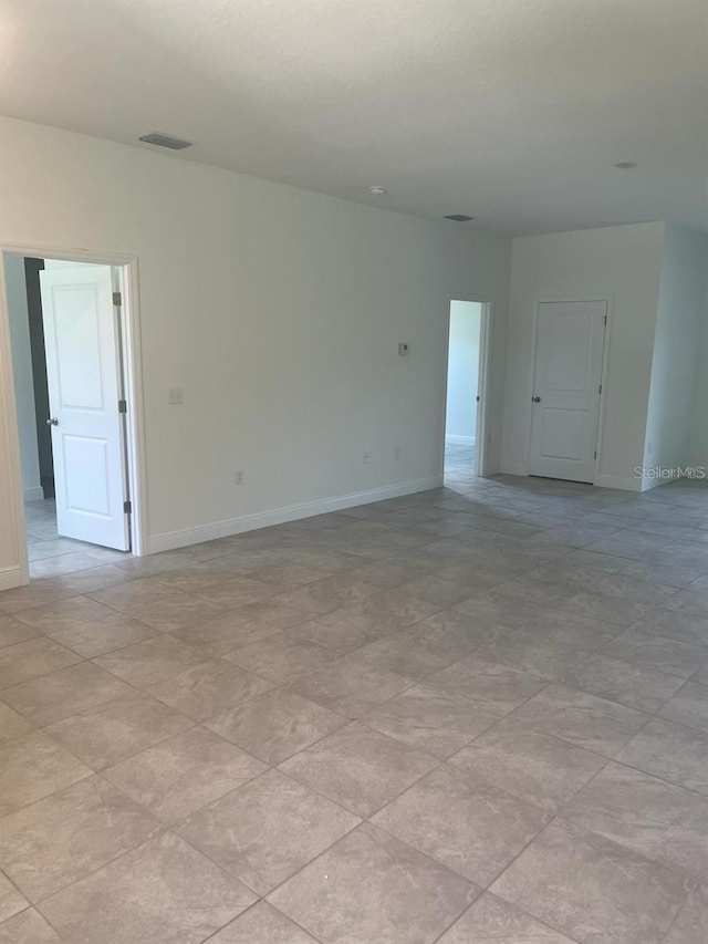 spare room with light tile patterned floors