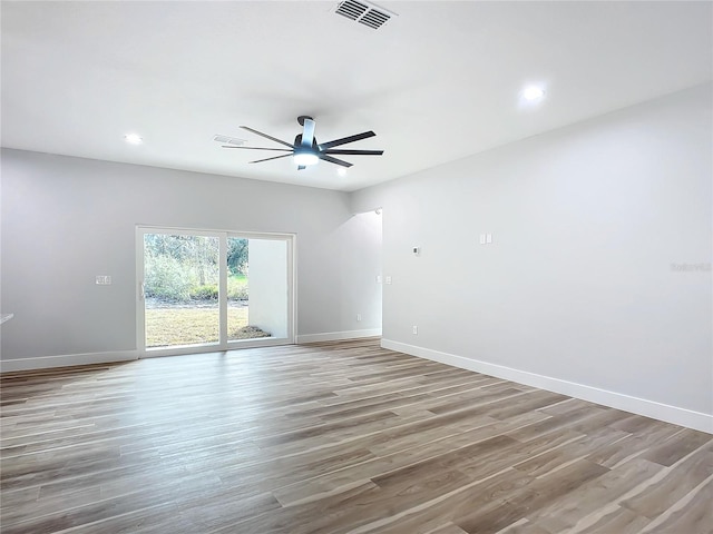 empty room with hardwood / wood-style flooring and ceiling fan