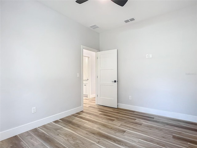 empty room featuring light hardwood / wood-style flooring and ceiling fan