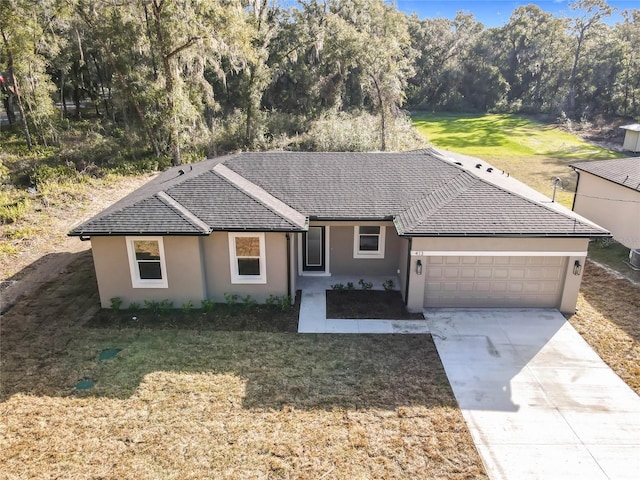 single story home with a garage and a front yard