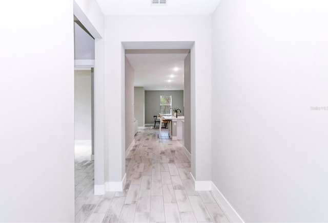 hall with light hardwood / wood-style flooring