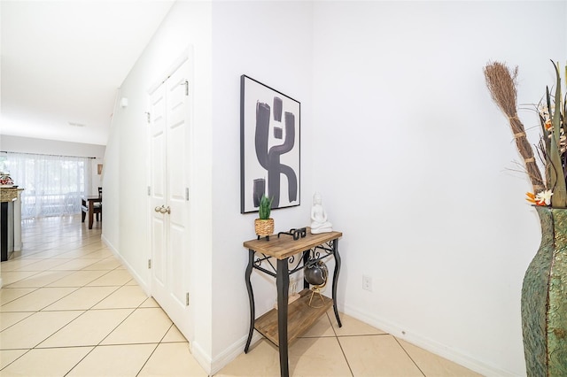 hall with light tile patterned floors