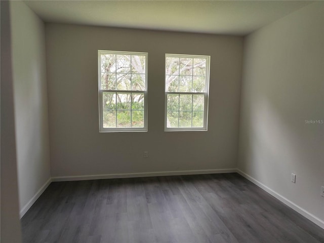 unfurnished room with dark hardwood / wood-style floors