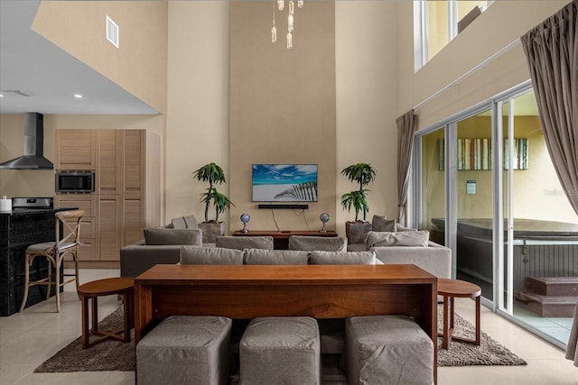 tiled living room featuring a towering ceiling