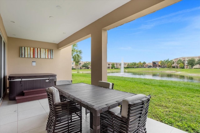 view of patio featuring a hot tub and a water view