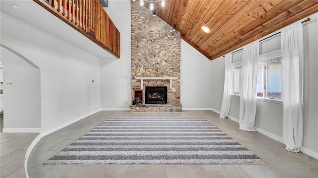 living room with wood ceiling, a fireplace, and high vaulted ceiling