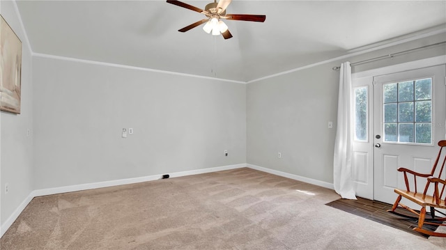 interior space featuring ceiling fan, ornamental molding, and carpet floors