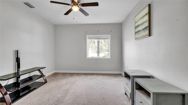 miscellaneous room featuring ceiling fan and light colored carpet