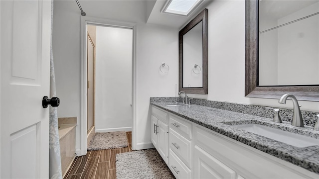 bathroom with vanity and walk in shower