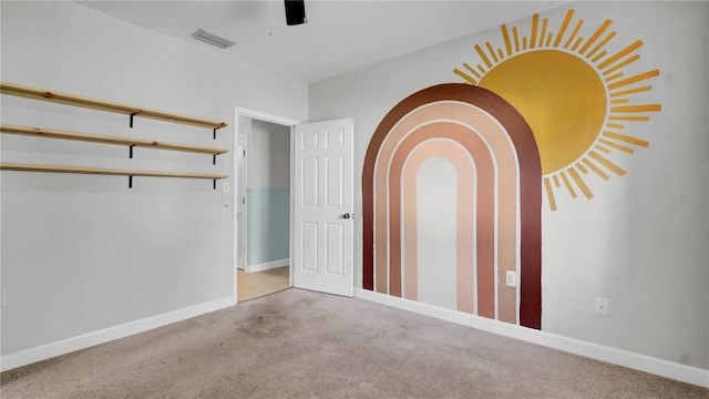 unfurnished bedroom with light carpet, a closet, and ceiling fan