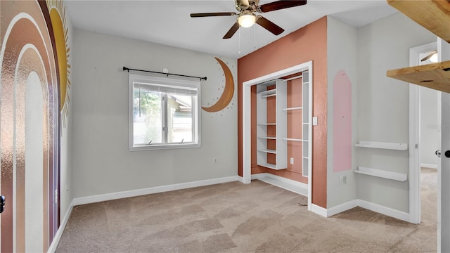 unfurnished bedroom featuring light carpet, ceiling fan, and a closet