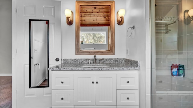 bathroom with vanity and a tile shower