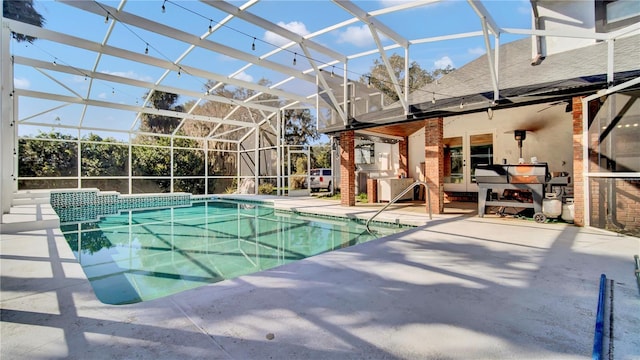 view of pool featuring a patio area and glass enclosure