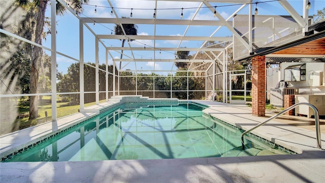 view of swimming pool with exterior kitchen, a patio, and glass enclosure