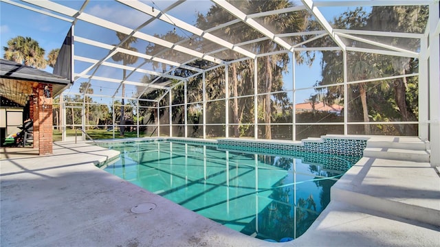 view of pool with a patio and glass enclosure